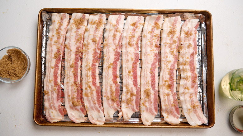 sprinkling the bacon with brown sugar