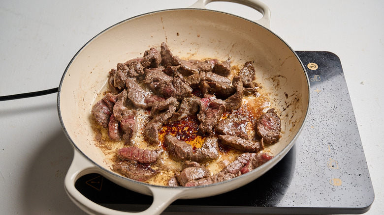 searing steak in a skillet
