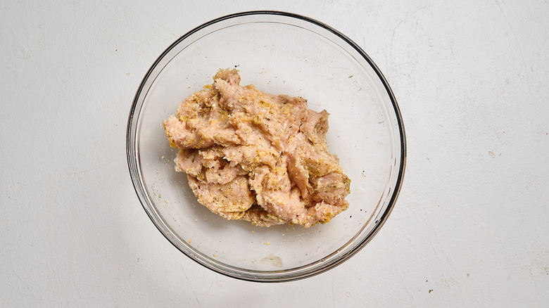 chicken and meatball ingredients combined in a bowl