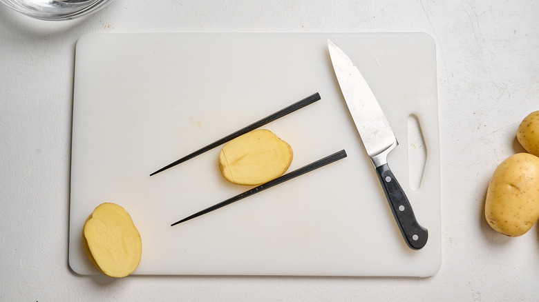 slicing potatoes horizontally across with a knife