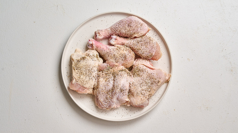 seasoning chicken with salt and pepper