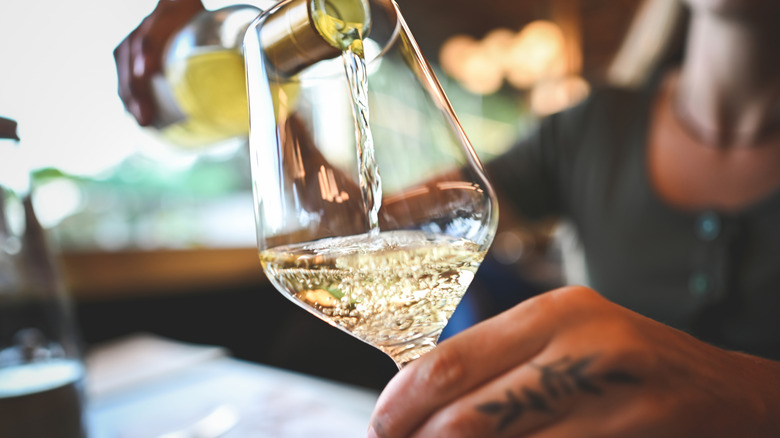 Foodie pouring a glass of white wine