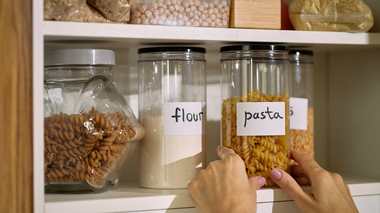 Person grabbing decanted pantry items
