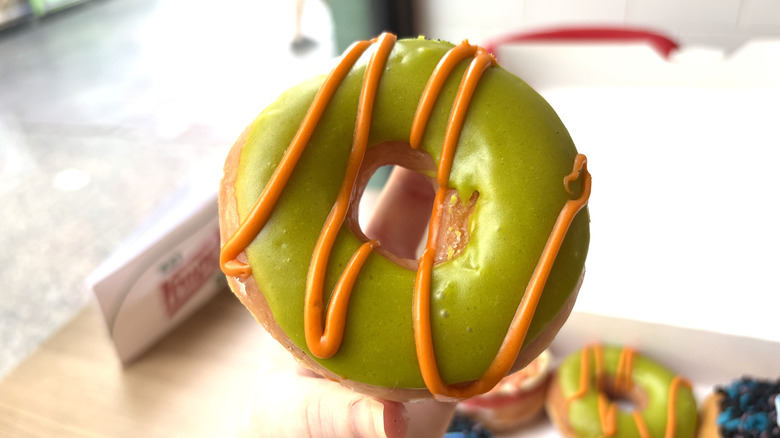 The new Krispy Kreme Cringer Claw Cookie Dough Doughnut with green and orange frosting