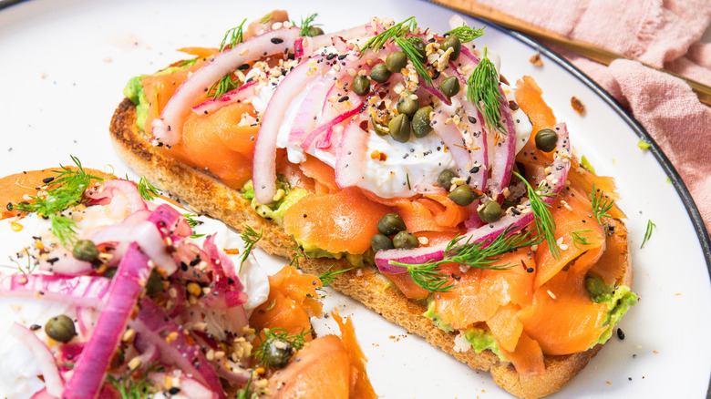 Close up on slice of smoked salmon avocado toast.