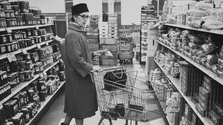 A woman grocery shopping in 1960
