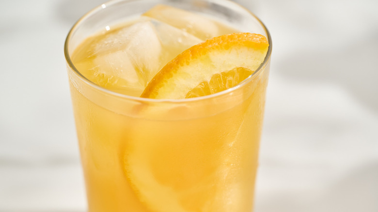 close up of an orange slice in a cocktail glass
