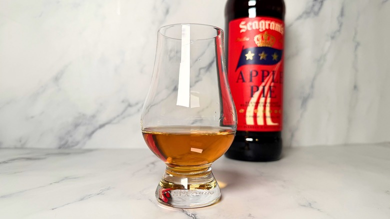 Whiskey in glencairn, Seagram's Apple Pie whiskey bottle behind