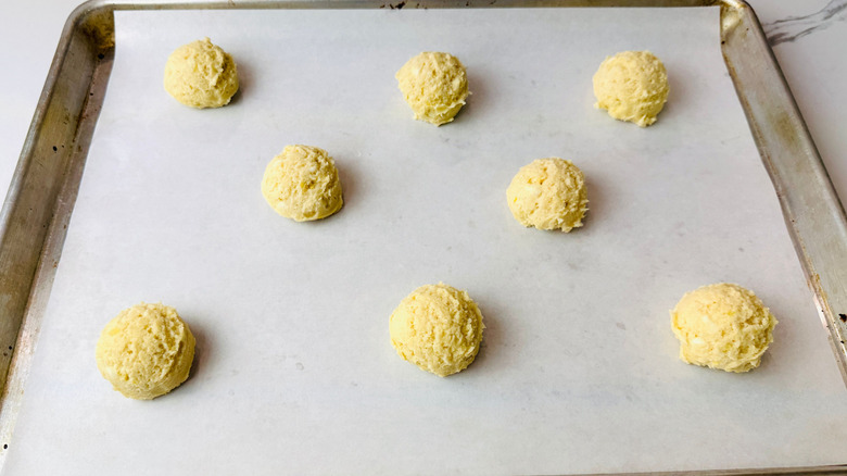Cookie dough balls on baking sheet