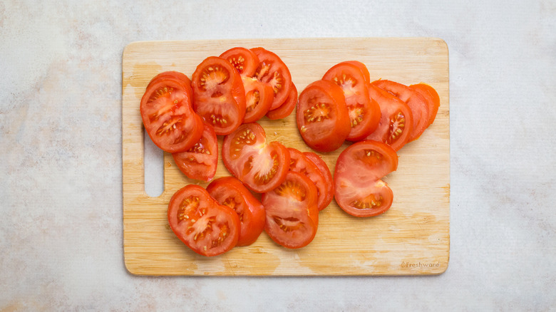 sliced tomatoes on cutting board