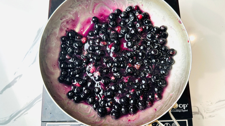 Blueberries simmering in pan