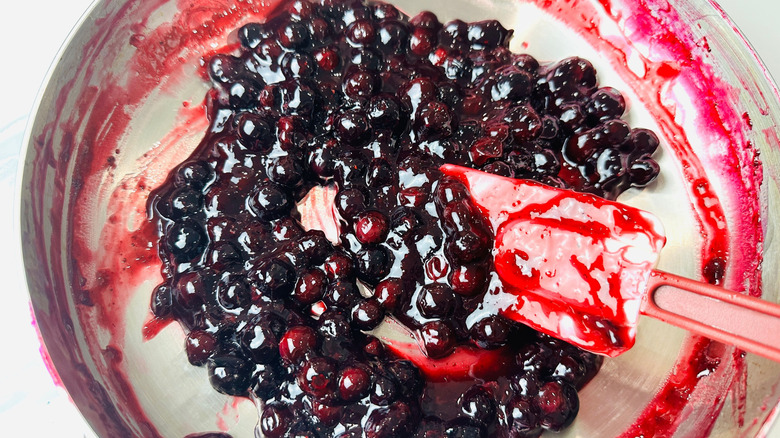 Blueberry pie filling in pan with spatula