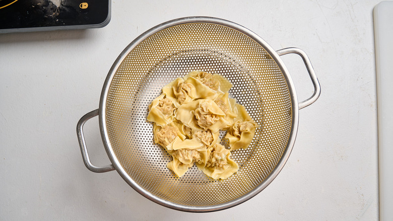 draining wontons in colander