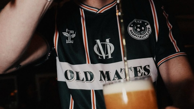 Bartender pouring beer in jersey at Old Mates Pub