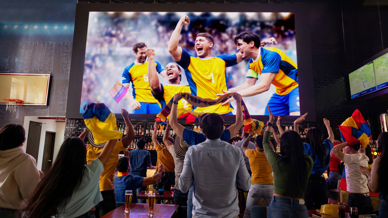 Fans watching a game at the bar