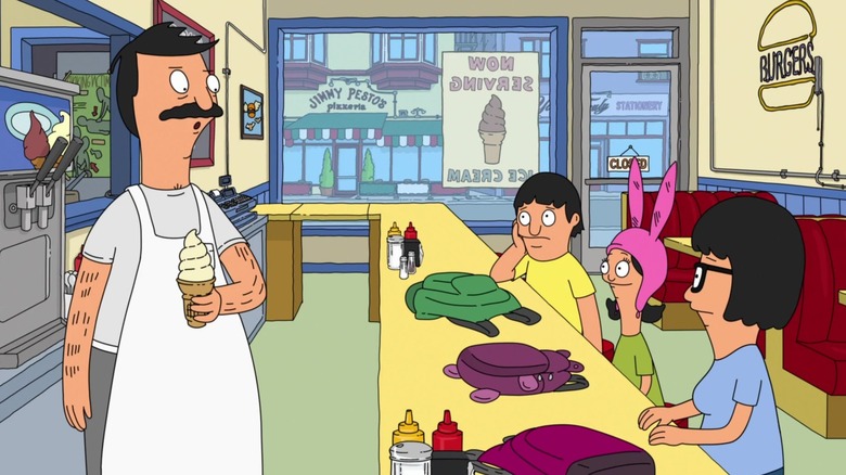 Bob speaks to his three children, who are sitting at the counter in the restaurant, in a still from season two of "Bob's Burgers"