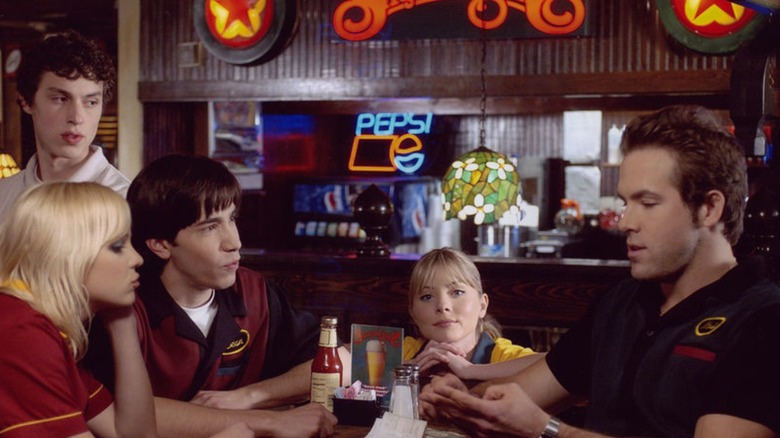 The Shenaniganz crew sitting at a booth in the flashy restaurant in a still from 