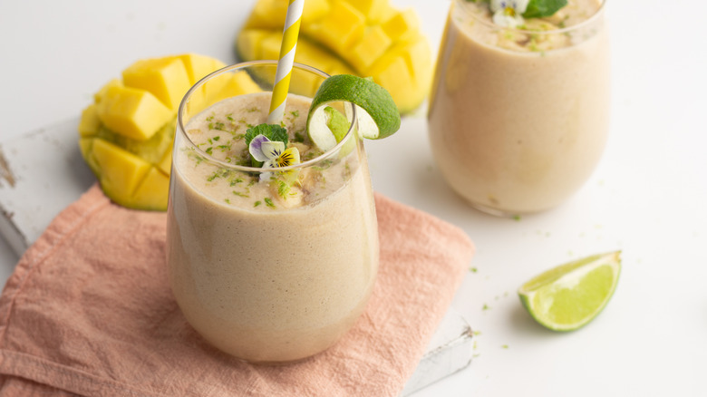 Smoothies garnished with lime peels and edible flower
