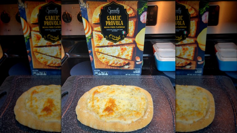 A box of Aldi's Garlic Provola flatbread with the freshly baked item in front