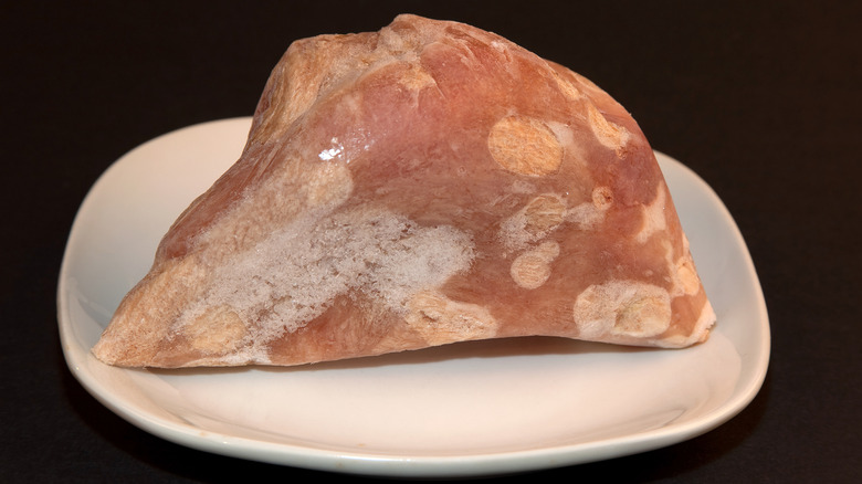 A frozen turkey breast with visible freezer burn