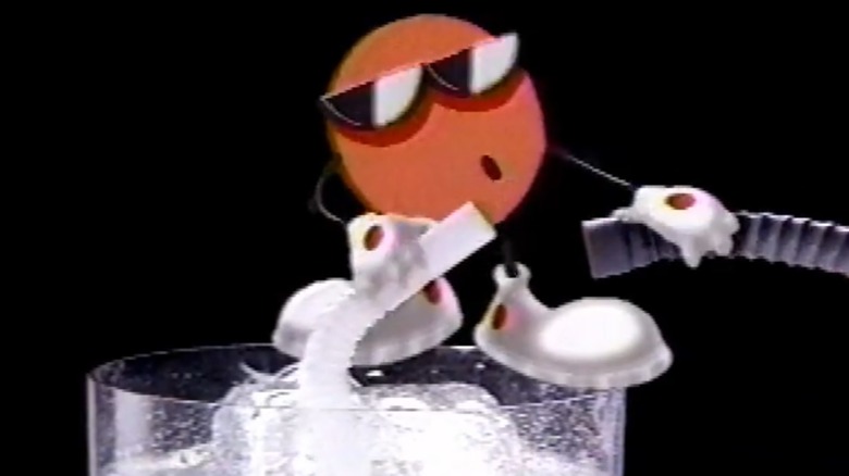 Cool Spot mascot on top of glass of soda with straw