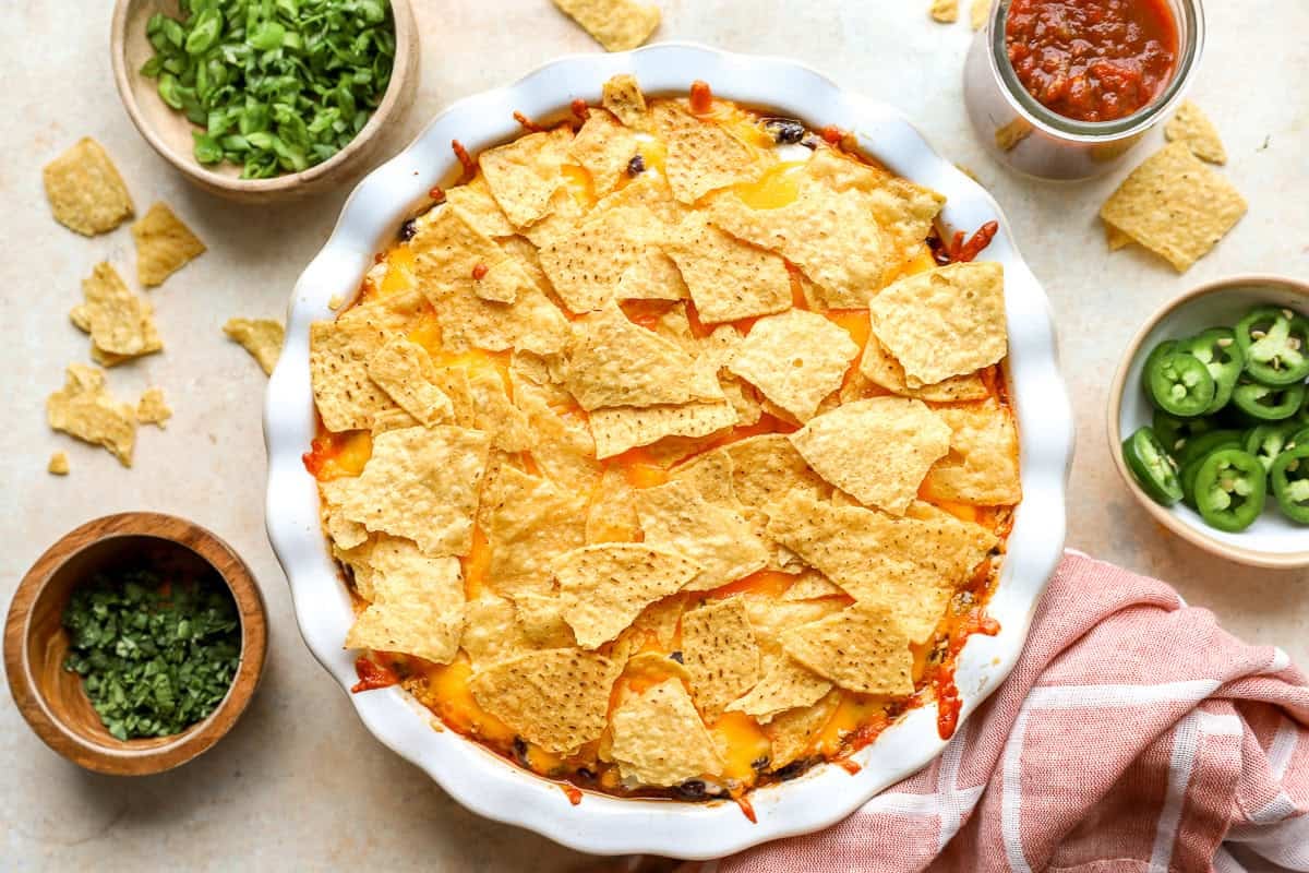 Baked nacho pie with melted cheddar cheese and crispy tortilla chips fresh from the oven