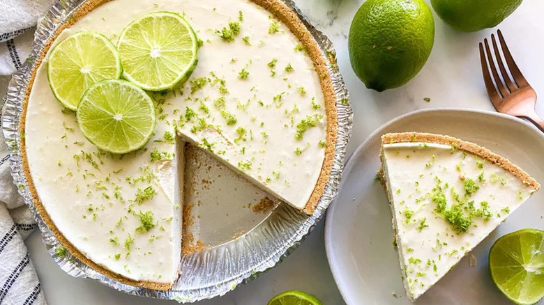 Vegan Key Lime Pie in aluminum pie plate and on white plate