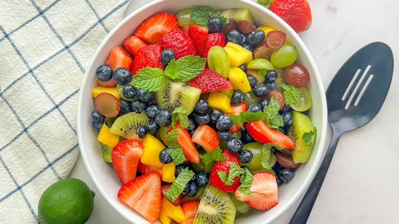 Simple Fruit Salad with Honey-Lime Dressing in large white bowl