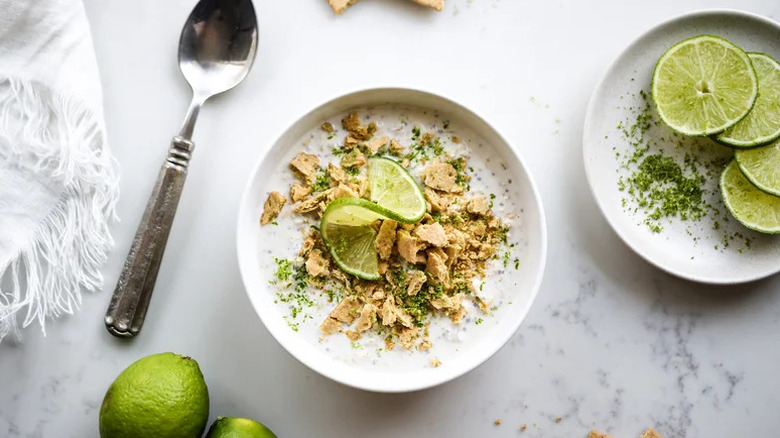 Key Lime Cheesecake Overnight Oats in white bowl with lime on top