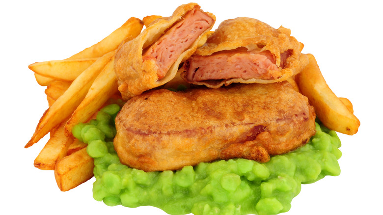 Spam fritters on top of mushy peas with side of fries