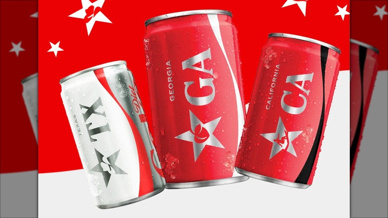 Three limited-edition Coca-Cola cans on red and white background
