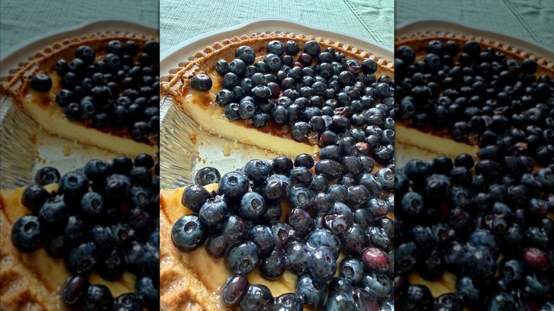 A close-up of a Kirkland Signature Blueberry Custard Pie with a slice cut out of it