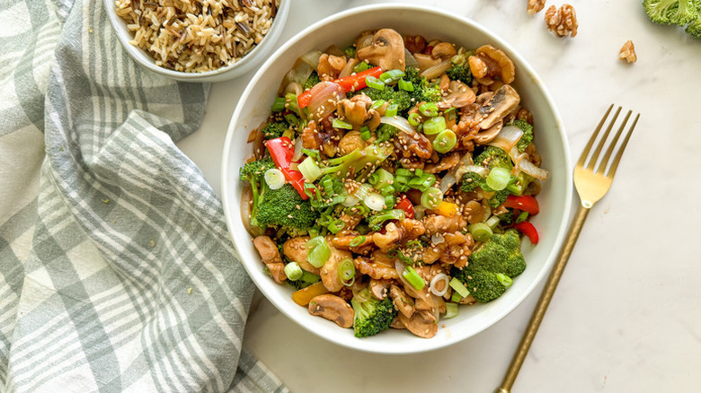 Bowl of walnut, mushroom, and broccoli stir fry