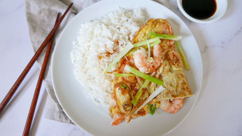 Shrimp egg foo young in dish with rice and sliced green onions