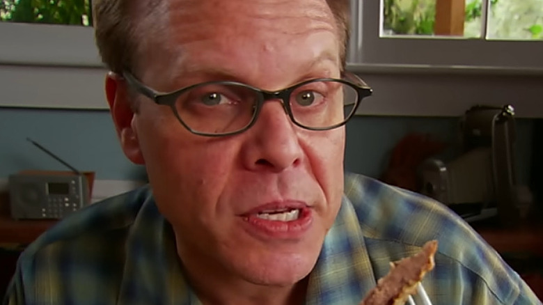 Alton Brown trying a dish on Good Eats