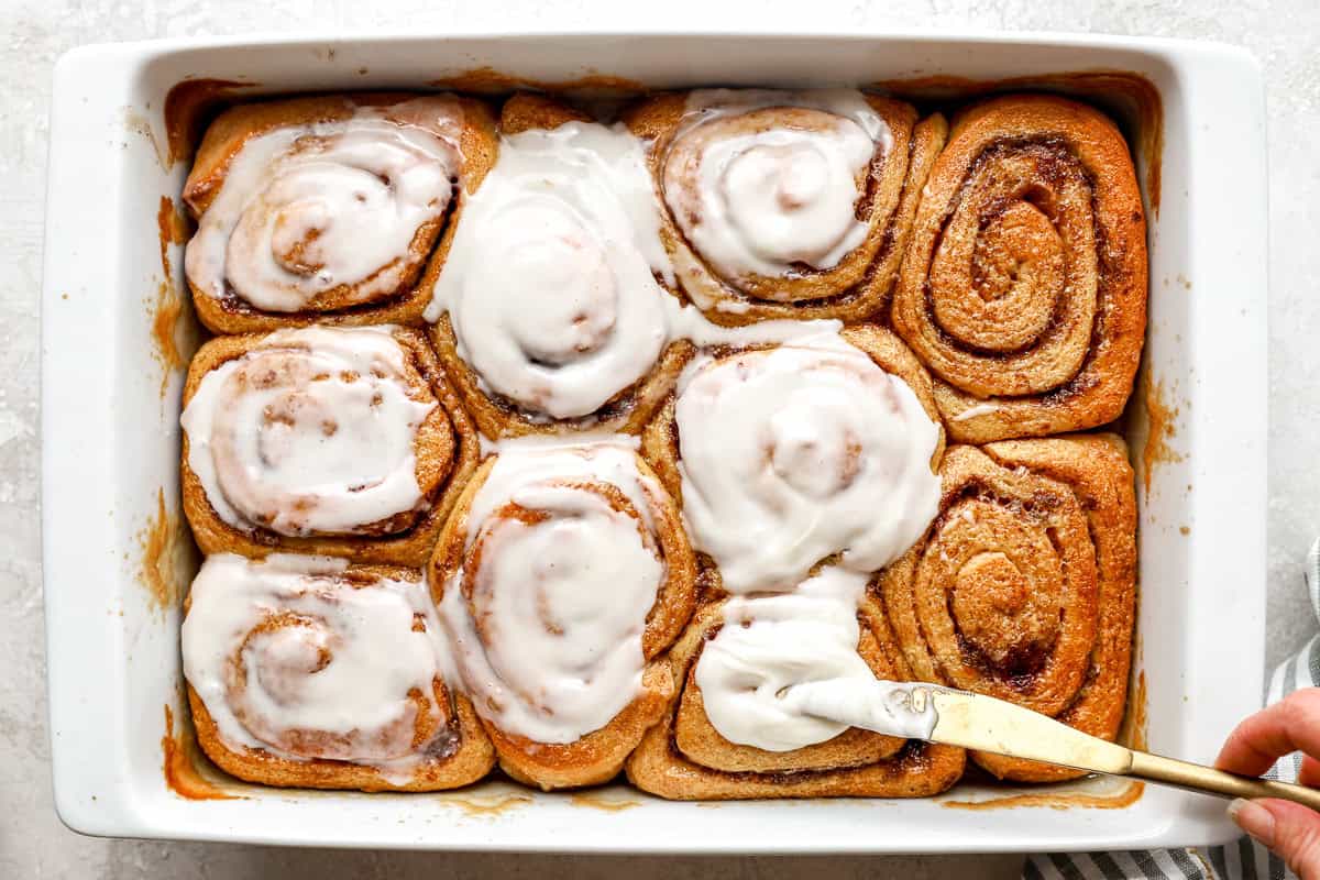 frosting cinnamon rolls from the oven