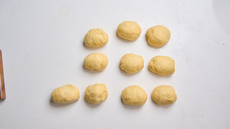 dough kneaded into smooth balls on a table