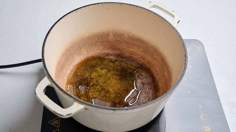 heating oil in a dutch oven on the stove