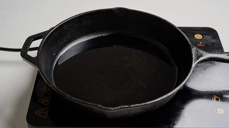 heating oil in a cast iron skillet