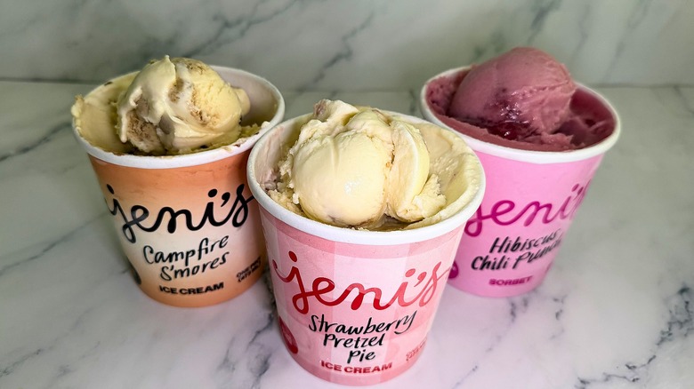 Three pints of Jeni's ice cream opened, with scoops of each sitting on top