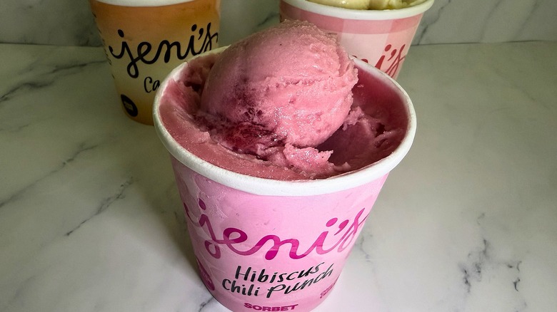 Open pint of Jeni's Hibiscus Chili Punch sorbet, two other open pints in background