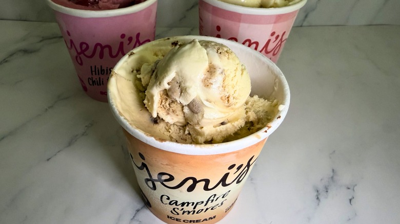 Open pint of Jeni's Campfire S'mores ice cream, two other open pints in background