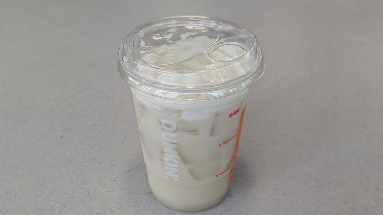 A Coconut Suncloud Limeade from Dunkin' on a grey table