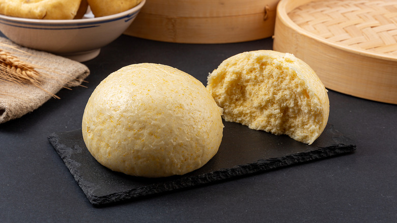 Chinese mantou steamed buns on a black slate