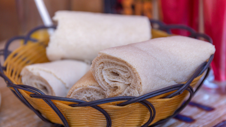 Rolls of injera bread in a basket