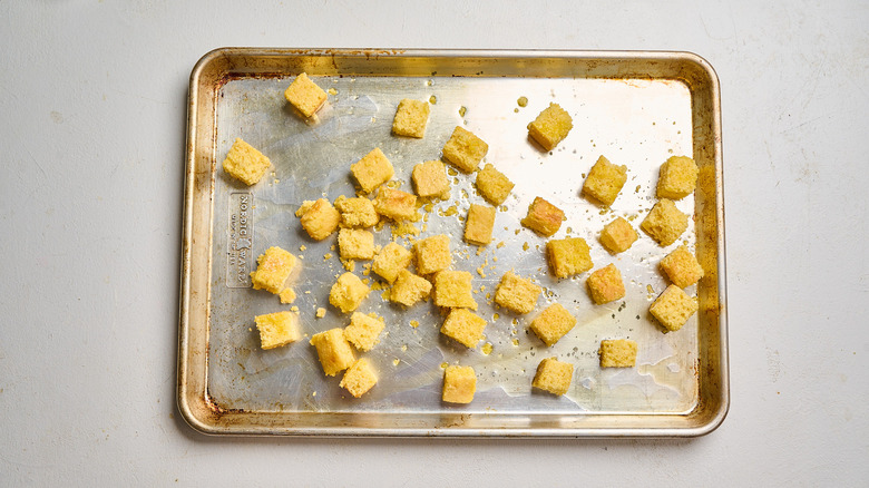 cubes of cornbread on a sheet tray