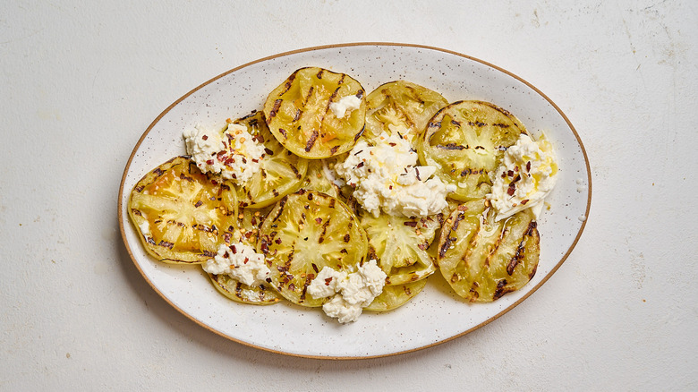 Tomatoes and burrata drizzled with oil