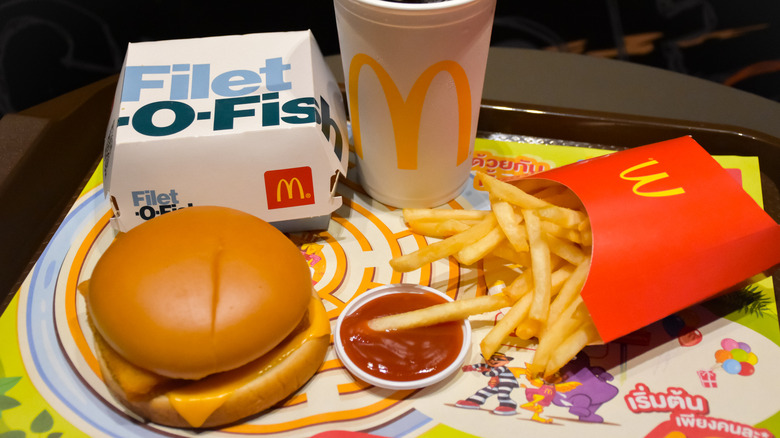 A Filet-O-Fish meal on a tray lined with paper featuring Thai writing