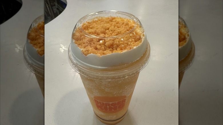 Burger King Orange Dreamsicle Freezee King in a clear cup with orange topping