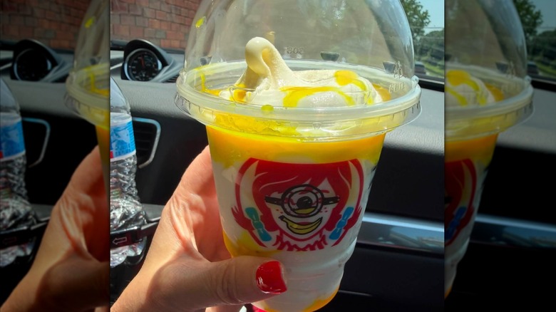A Wendy's Frosty cup featuring a minions version of Wendy with a yellow swirled Frosty